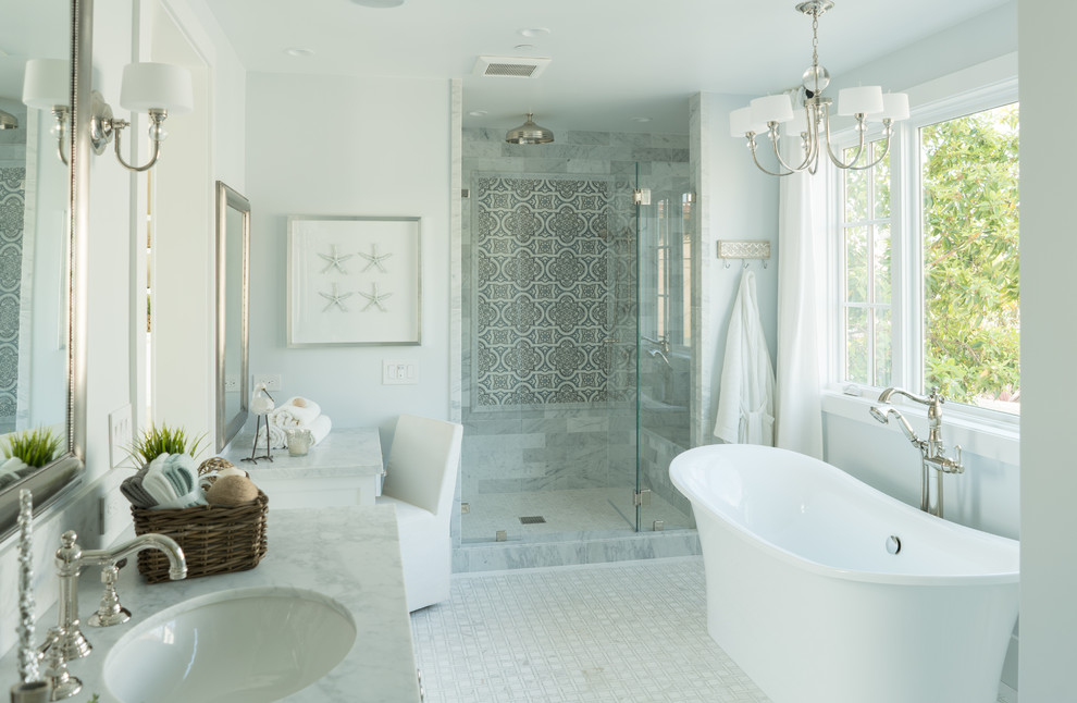 Beach style master bathroom in Orange County with a freestanding tub, an alcove shower, gray tile, white tile, blue walls, mosaic tile floors, an undermount sink and a hinged shower door.