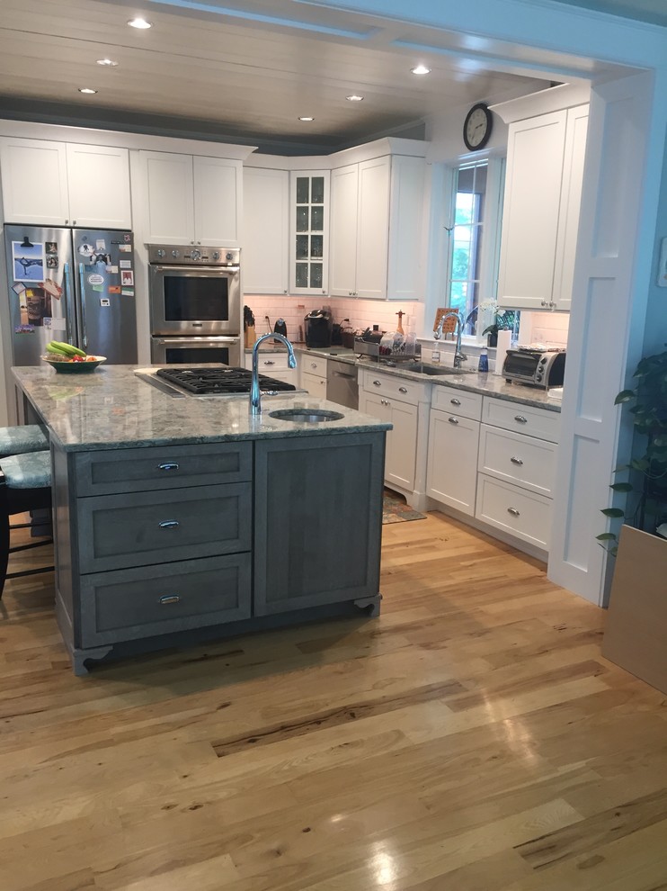 This is an example of a large transitional u-shaped kitchen in Other with a single-bowl sink, shaker cabinets, medium wood cabinets, quartz benchtops, with island and multi-coloured benchtop.