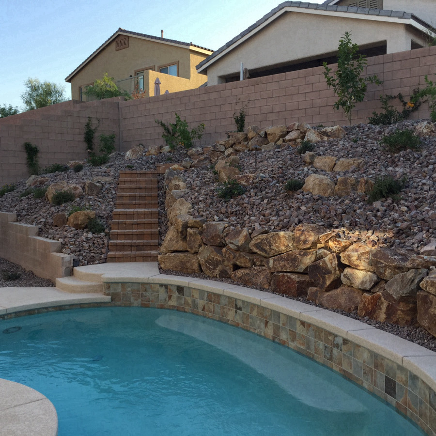 This is an example of a mid-sized traditional backyard kidney-shaped pool in Las Vegas with concrete slab.