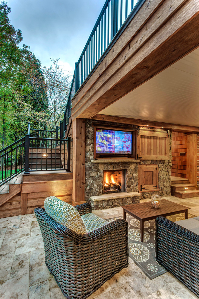Inspiration for a large country backyard patio in Charlotte with a fire feature, tile and a roof extension.