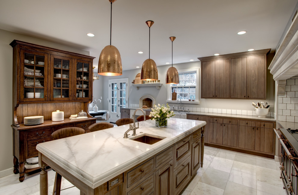 Design ideas for a large country u-shaped separate kitchen in Kansas City with flat-panel cabinets, distressed cabinets, marble benchtops, white splashback, subway tile splashback, stainless steel appliances, marble floors, with island and an undermount sink.