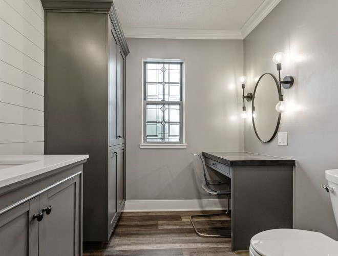 Example of a transitional 3/4 gray tile vinyl floor, gray floor, double-sink and wainscoting bathroom design in Columbus with recessed-panel cabinets, gray cabinets, quartzite countertops, turquoise countertops and a built-in vanity