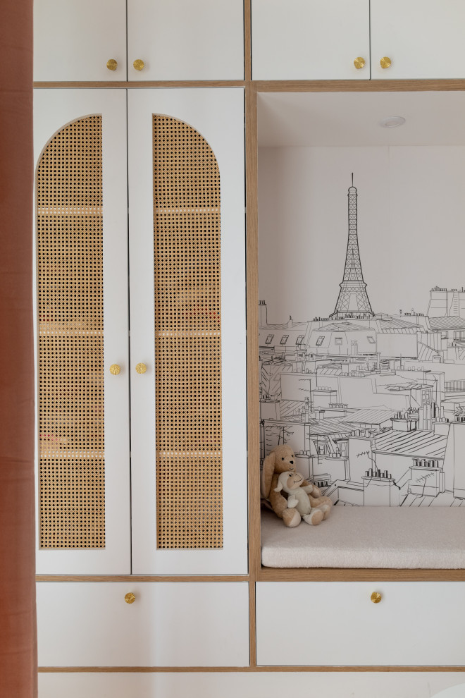 Large contemporary kids' bedroom for girls in Paris with white walls, light hardwood flooring and brown floors.