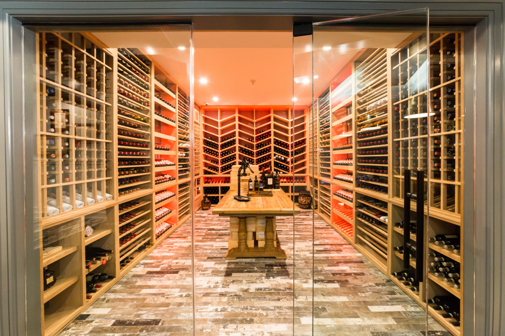 Design ideas for a large modern wine cellar in New York with porcelain floors, display racks and grey floor.