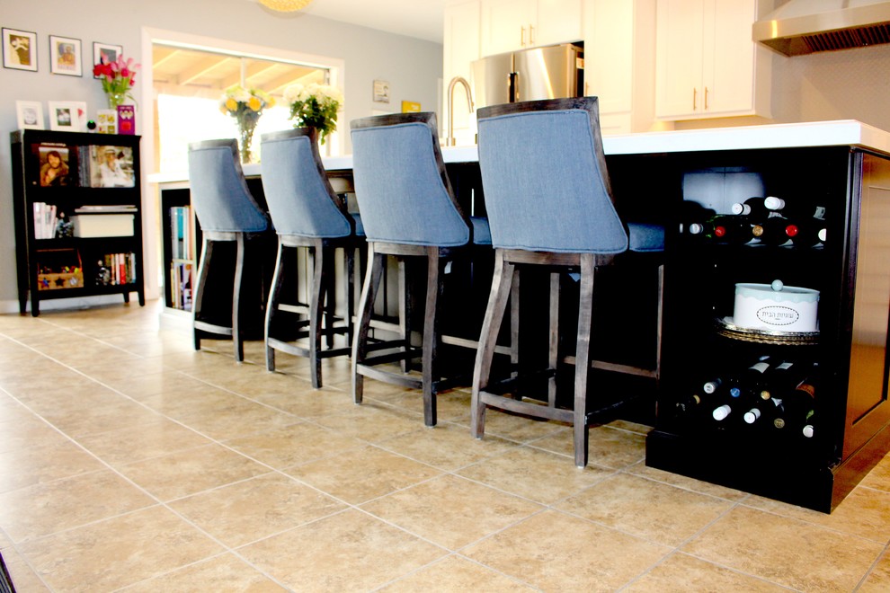 Inspiration for a large transitional l-shaped ceramic tile and beige floor open concept kitchen remodel in Phoenix with an undermount sink, shaker cabinets, white cabinets, quartzite countertops, gray backsplash, stainless steel appliances and an island