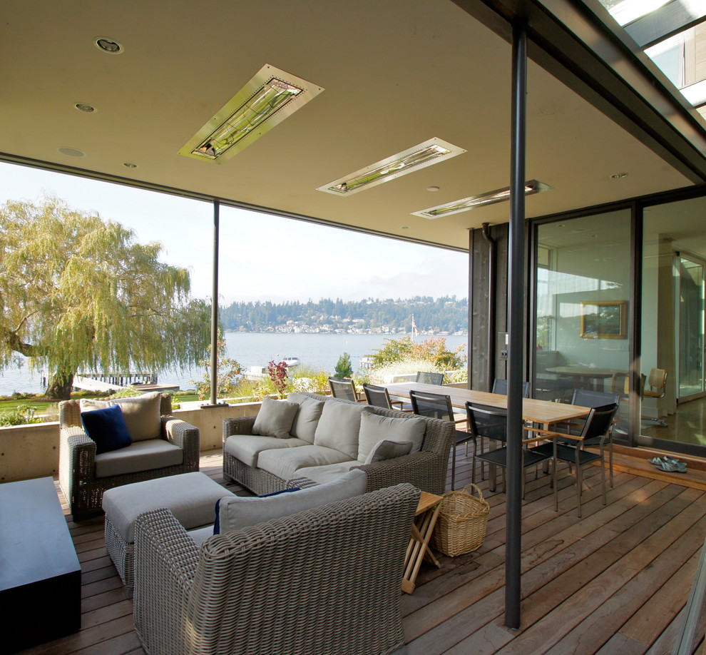 Modern side yard verandah in Seattle with decking and a roof extension.
