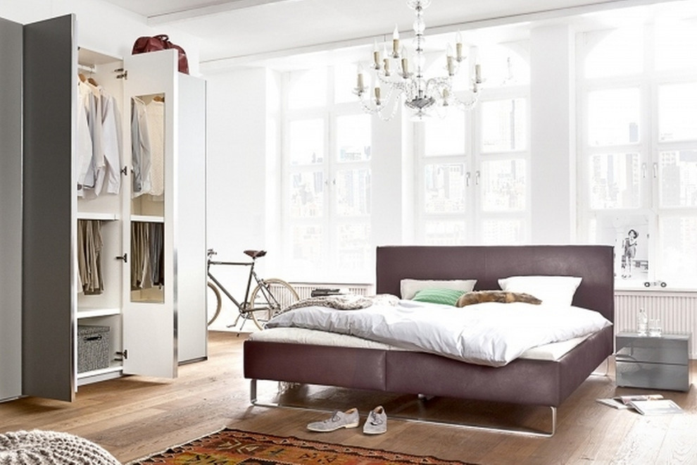 Inspiration for a large contemporary master bedroom in Nuremberg with white walls, medium hardwood floors and no fireplace.