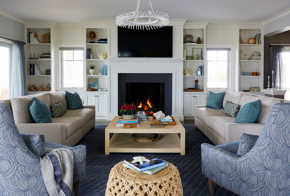 This is an example of a beach style enclosed family room in New York with a standard fireplace and a wall-mounted tv.