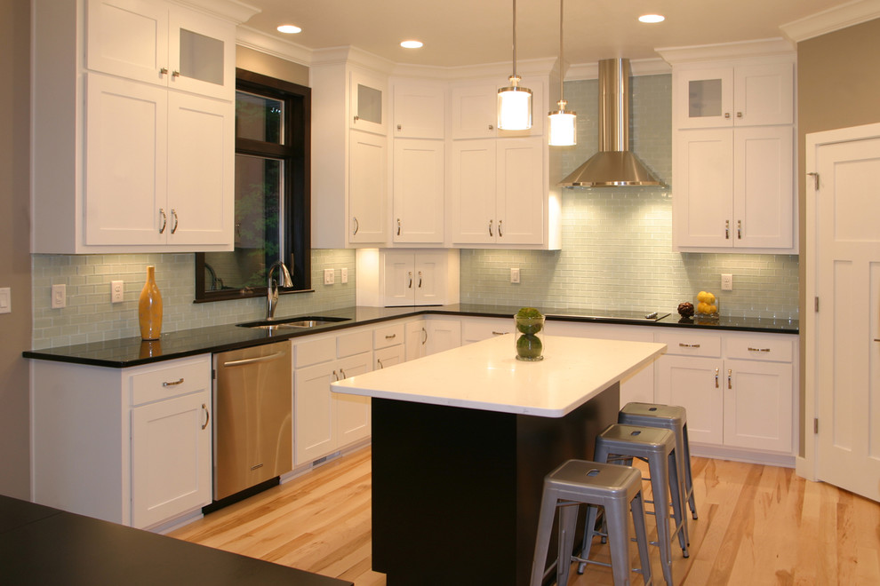 Inspiration for a large transitional l-shaped medium tone wood floor and beige floor enclosed kitchen remodel with a double-bowl sink, shaker cabinets, white cabinets, quartz countertops, blue backsplash, glass tile backsplash, stainless steel appliances and an island