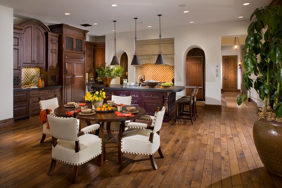 Design ideas for a mediterranean kitchen/dining combo in Orange County with white walls and dark hardwood floors.