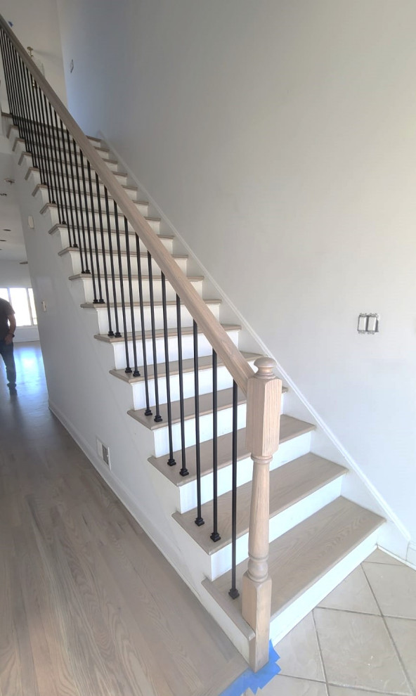 Example of a mid-sized trendy wooden straight mixed material railing staircase design in New York with wooden risers