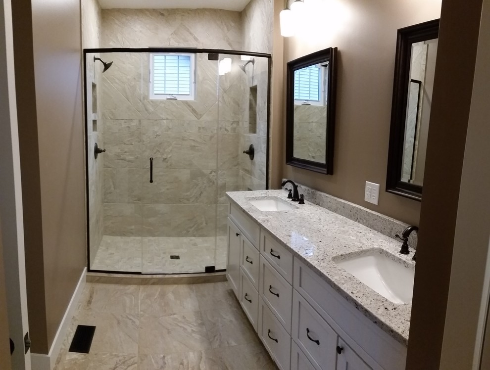 Mid-sized arts and crafts 3/4 bathroom in St Louis with shaker cabinets, white cabinets, an alcove shower, a two-piece toilet, beige tile, stone tile, brown walls, marble floors, an undermount sink, engineered quartz benchtops, beige floor and a hinged shower door.