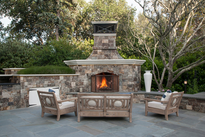 Photo of a large traditional backyard patio in San Francisco with natural stone pavers, a fire feature and no cover.