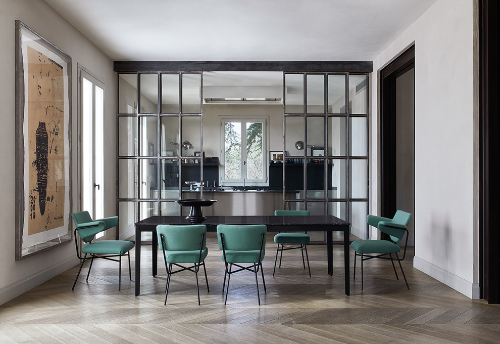 This is an example of a modern dining room in Milan with grey walls, light hardwood floors and beige floor.