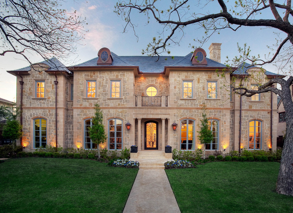 Design ideas for a large traditional beige exterior in Dallas with stone veneer.