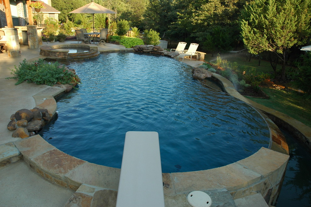 Hot tub - mid-sized rustic backyard concrete and custom-shaped natural hot tub idea