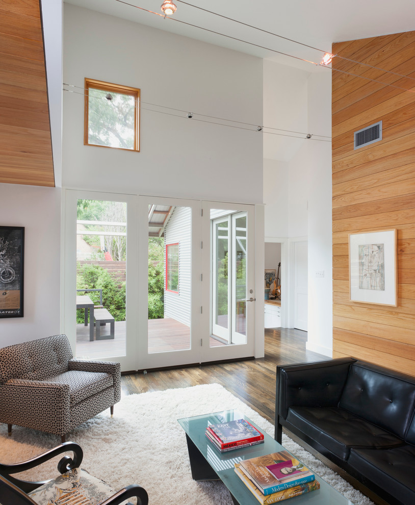 Inspiration for a contemporary living room in Austin with white walls and dark hardwood floors.