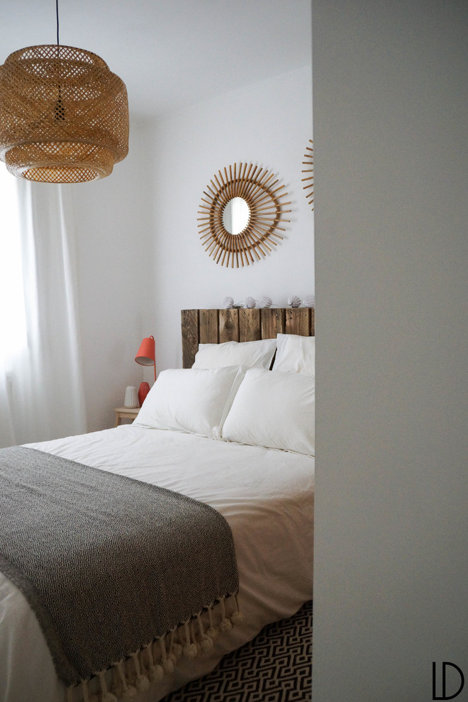 This is an example of a small scandinavian guest bedroom in Toulouse with white walls, laminate floors and no fireplace.