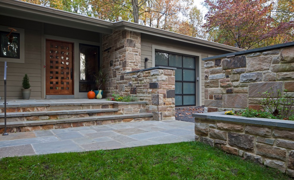 Large contemporary front yard verandah in Baltimore with natural stone pavers and a roof extension.