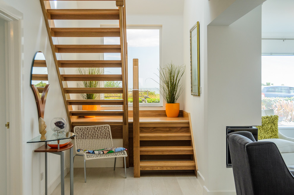 Inspiration for a mid-sized modern wood l-shaped staircase in Belfast with open risers.