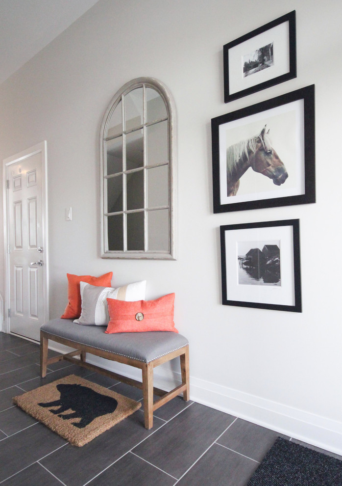 This is an example of a transitional entryway in Ottawa with grey walls and grey floor.