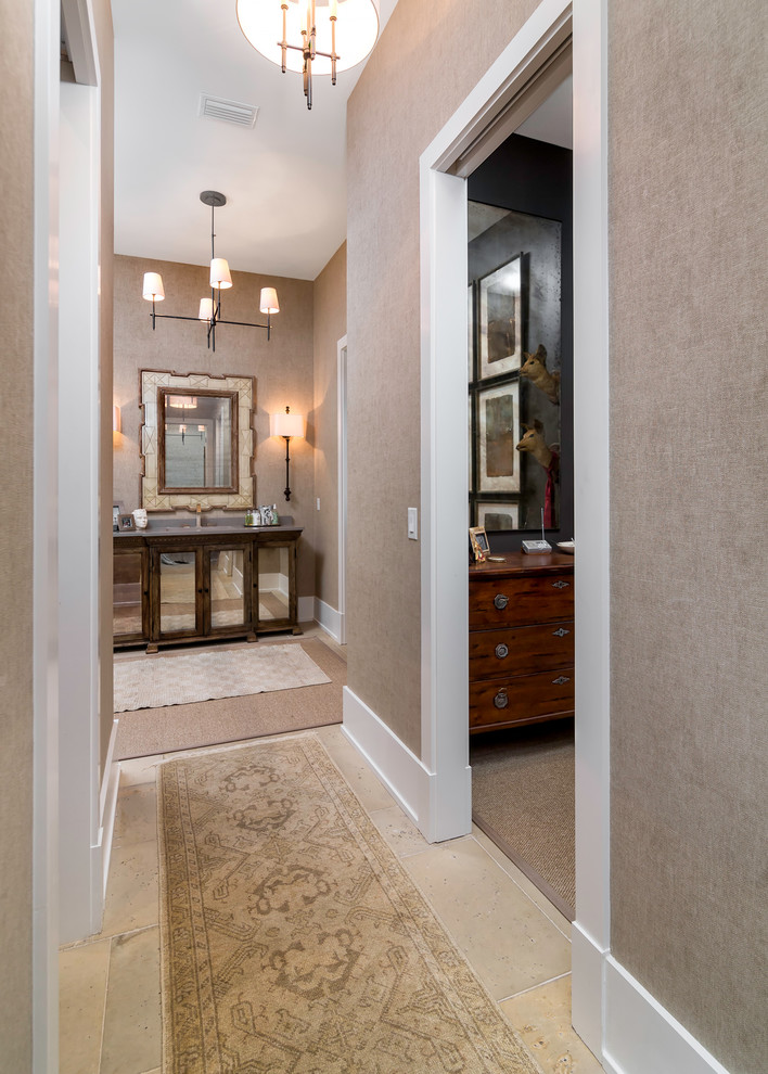 Photo of a mid-sized beach style hallway in Atlanta with beige walls and travertine floors.