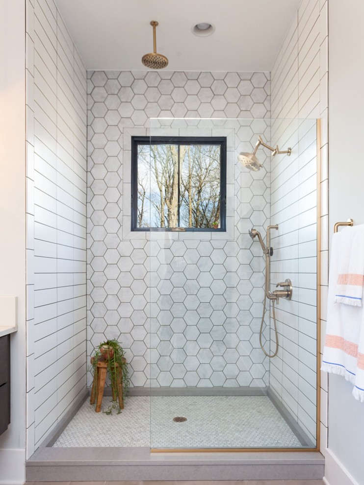 Design ideas for a mid-sized country master bathroom in Other with flat-panel cabinets, dark wood cabinets, a freestanding tub, an alcove shower, gray tile, marble, grey walls, cement tiles, an undermount sink, marble benchtops, grey floor, a hinged shower door and white benchtops.