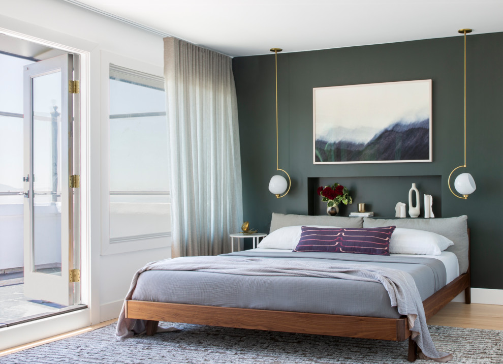 Inspiration for a contemporary bedroom in San Francisco with green walls, light hardwood floors and beige floor.