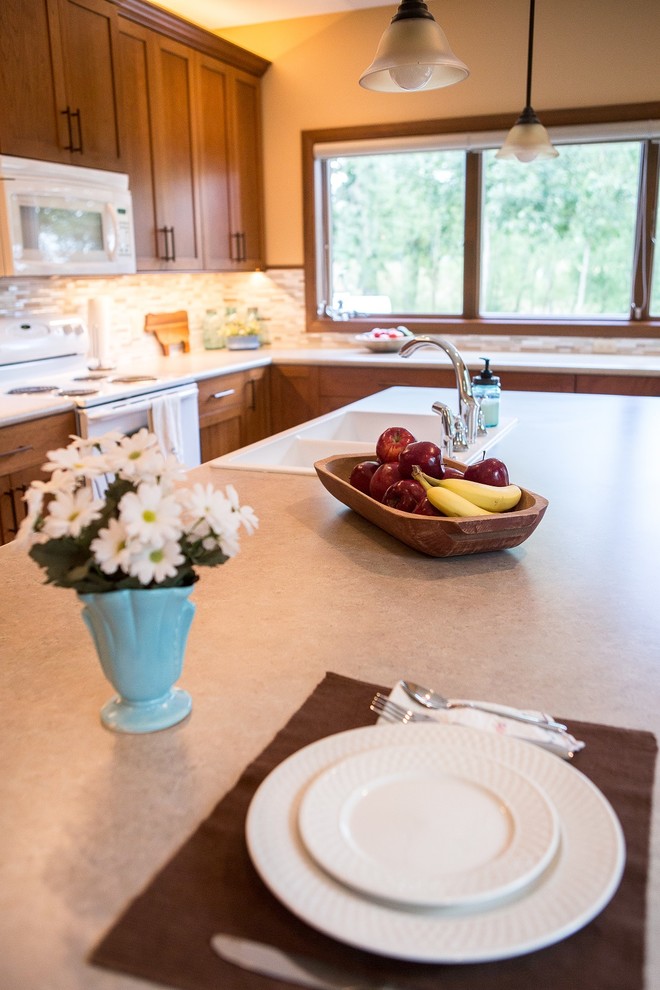 Example of a large transitional l-shaped light wood floor eat-in kitchen design in Cedar Rapids with a double-bowl sink, recessed-panel cabinets, medium tone wood cabinets, laminate countertops, multicolored backsplash, mosaic tile backsplash, white appliances and an island