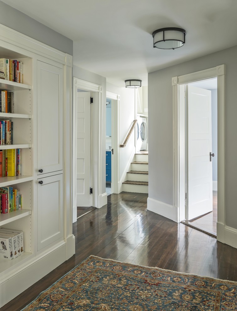 Inspiration for a mid-sized country hallway in Boston with grey walls and light hardwood floors.