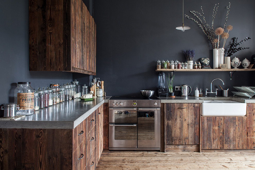 Inspiration for a large country l-shaped separate kitchen in London with a farmhouse sink, flat-panel cabinets, dark wood cabinets and concrete benchtops.