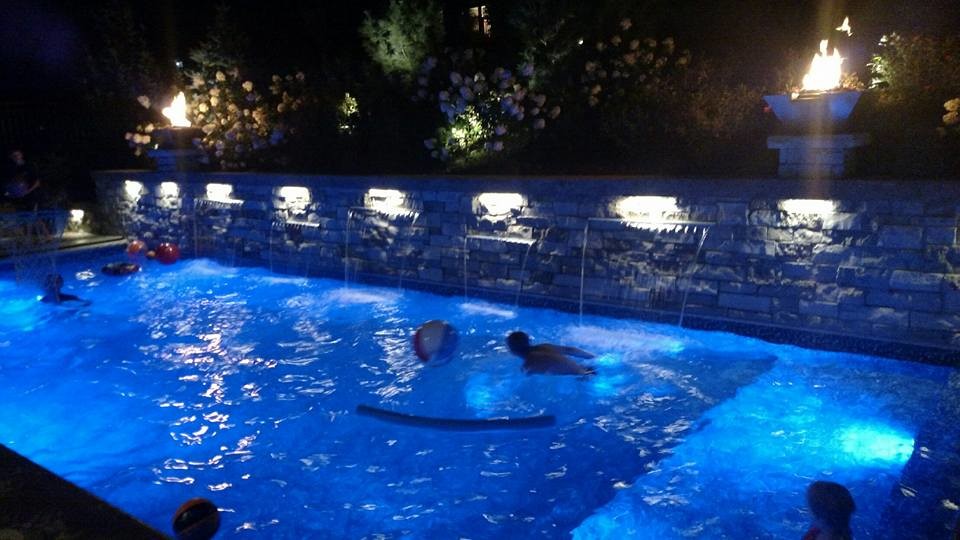 Mid-sized trendy backyard stamped concrete and kidney-shaped pool house photo