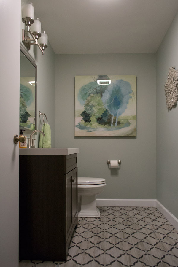 Design ideas for a small transitional powder room in Louisville with flat-panel cabinets, brown cabinets, a one-piece toilet, blue walls, ceramic floors, an undermount sink, quartzite benchtops and multi-coloured floor.