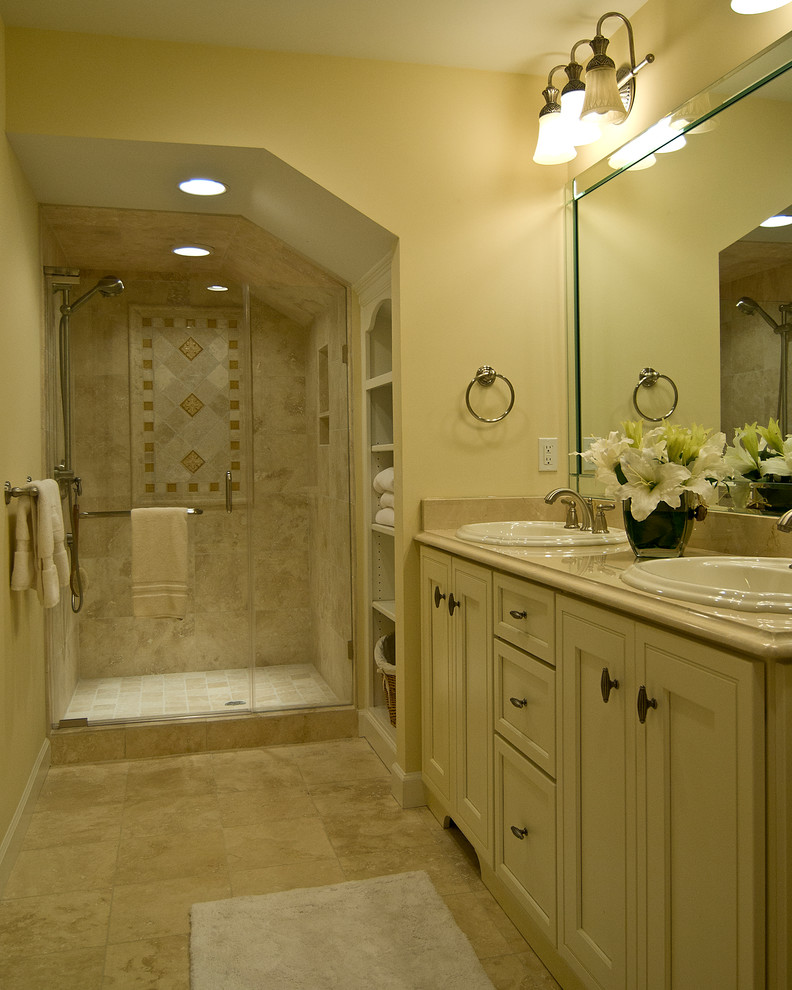 Inspiration for a mid-sized traditional 3/4 bathroom in Charlotte with shaker cabinets, beige cabinets, an alcove shower, beige tile, glass sheet wall, beige walls, ceramic floors, a drop-in sink, granite benchtops, beige floor and a hinged shower door.