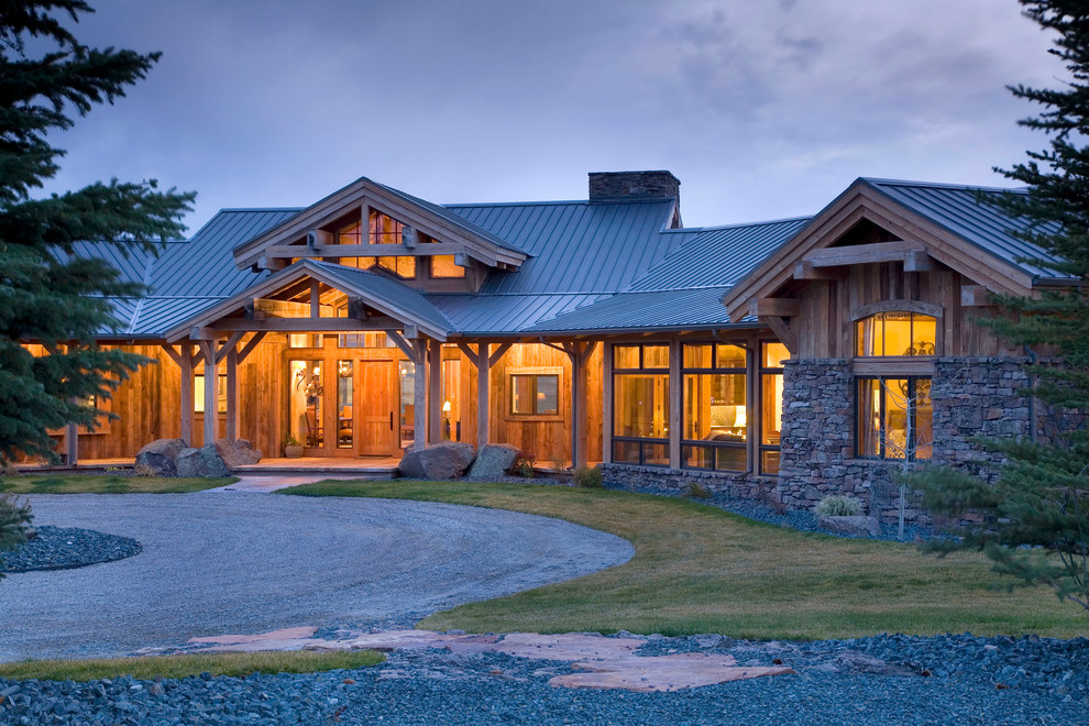 This is an example of a mid-sized country one-storey brown exterior in Other with wood siding.