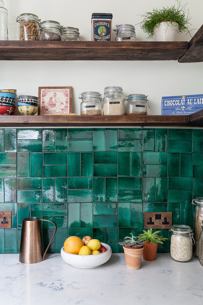 Inspiration for a small eclectic l-shaped separate kitchen in London with an integrated sink, shaker cabinets, white cabinets, marble benchtops, green splashback, ceramic splashback, panelled appliances, cement tiles, no island and white floor.