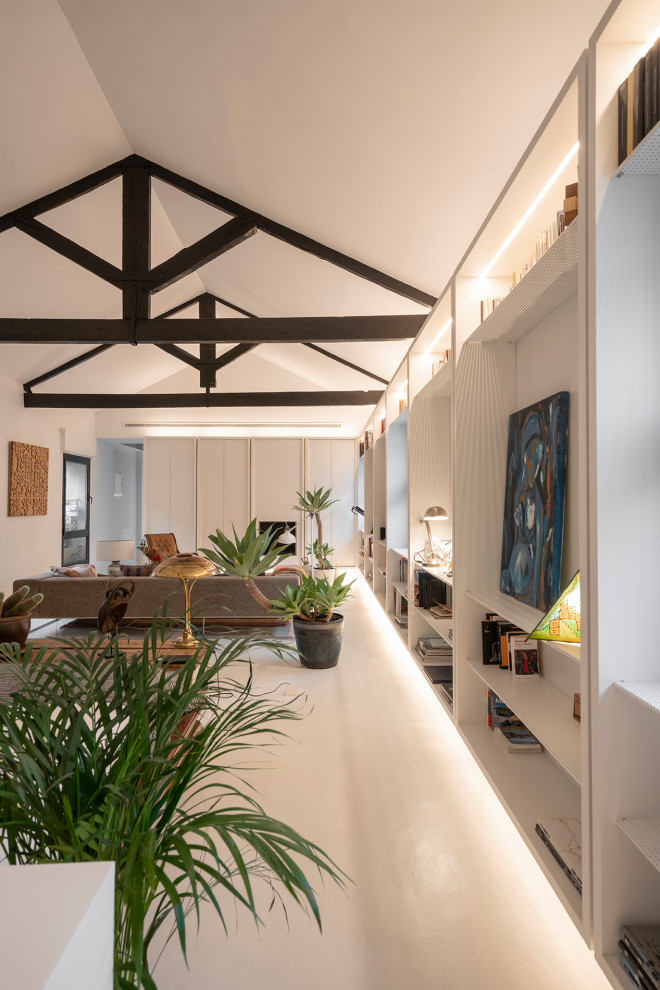 Photo of a large contemporary mezzanine bedroom in Madrid with white walls, concrete flooring, a standard fireplace, a metal fireplace surround, white floors and exposed beams.