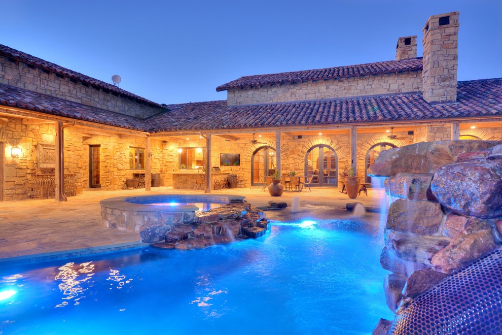 Inspiration for a rustic backyard stone and custom-shaped natural water slide remodel in Austin