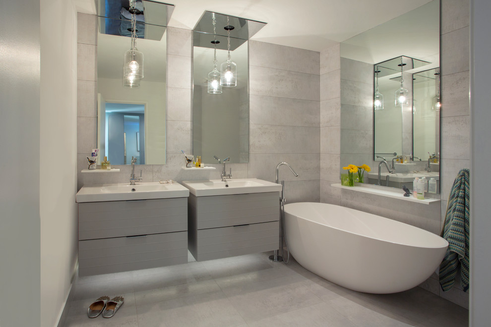 Photo of a contemporary master bathroom in Other with flat-panel cabinets, grey cabinets, a freestanding tub, gray tile, white walls, a console sink and grey floor.