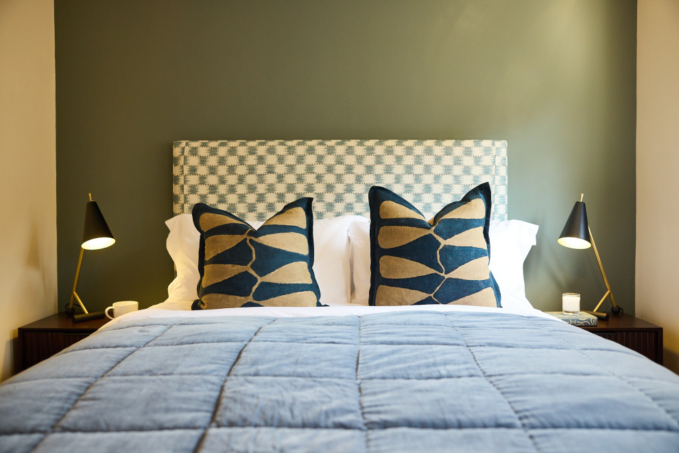 This is an example of a medium sized midcentury guest bedroom in Other with blue walls and carpet.