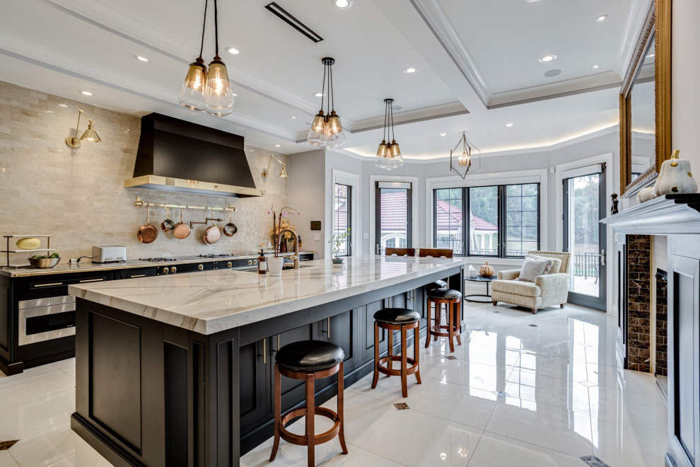 Photo of an expansive mediterranean galley eat-in kitchen in Other with a farmhouse sink, beaded inset cabinets, black cabinets, quartz benchtops, beige splashback, marble splashback, black appliances, marble floors, with island, multi-coloured floor and beige benchtop.