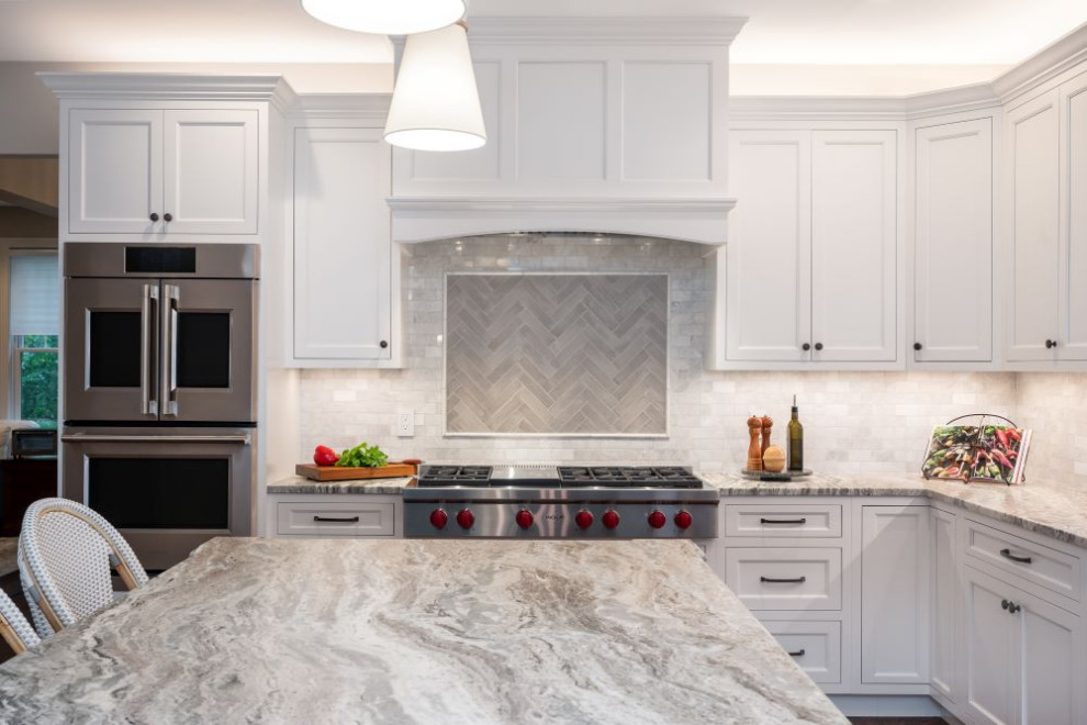 Eat-in kitchen - large transitional l-shaped eat-in kitchen idea with stainless steel appliances, an island and gray countertops