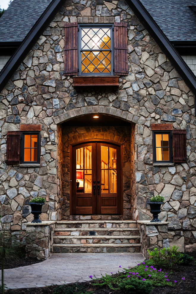 This is an example of a country front door in Raleigh with a dark wood front door and a double front door.