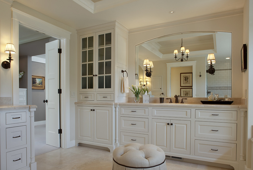 Inspiration for a traditional bathroom in San Francisco with raised-panel cabinets, white cabinets and beige tile.