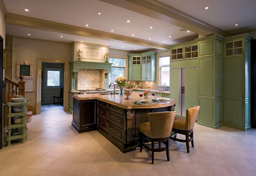 Eat-in kitchen - large transitional l-shaped ceramic tile and beige floor eat-in kitchen idea in Calgary with an undermount sink, raised-panel cabinets, green cabinets, granite countertops, beige backsplash, ceramic backsplash, paneled appliances and an island