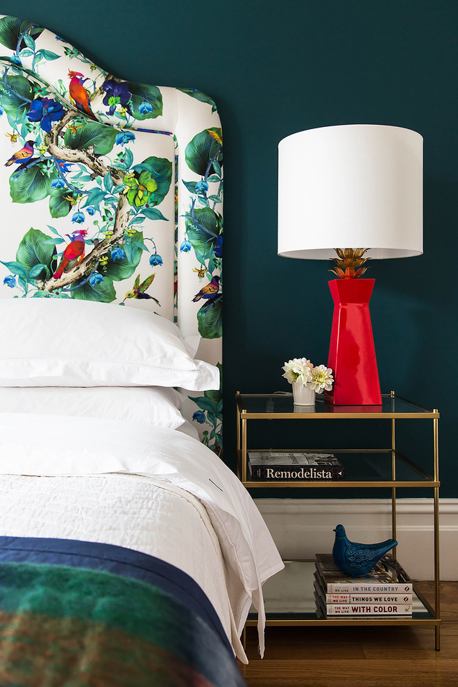 Inspiration for a mid-sized eclectic guest bedroom in Melbourne with green walls and medium hardwood floors.