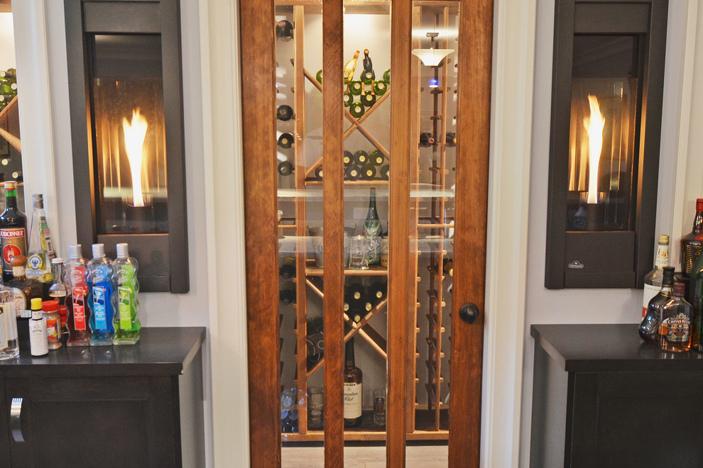 Inspiration for a small arts and crafts wine cellar in Vancouver with light hardwood floors and diamond bins.