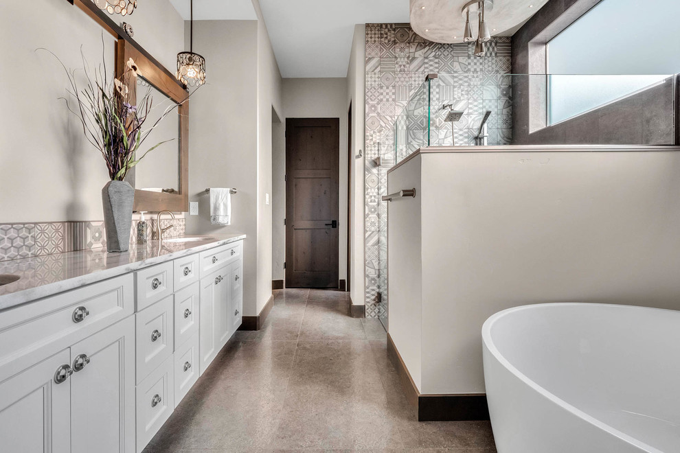 This is an example of a small modern master bathroom in Denver with raised-panel cabinets, white cabinets, a freestanding tub, a curbless shower, multi-coloured tile, ceramic tile, porcelain floors, an undermount sink, quartzite benchtops, grey floor, a hinged shower door and white benchtops.