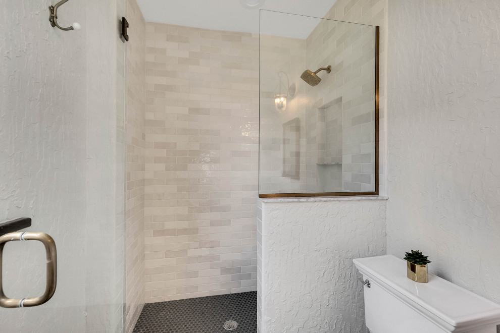 Mid-sized mediterranean bathroom in Tampa with brown cabinets, white tile, ceramic tile, white walls, ceramic floors, a vessel sink, wood benchtops, white floor, a hinged shower door, brown benchtops, a single vanity and a freestanding vanity.