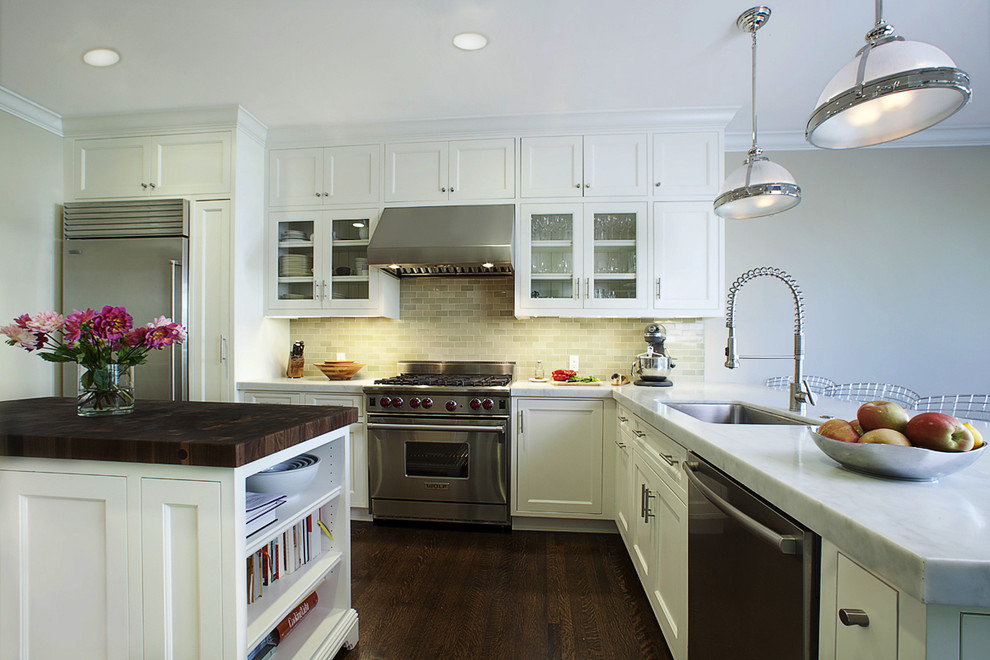 Photo of a traditional l-shaped kitchen in San Francisco with glass-front cabinets, marble benchtops, stainless steel appliances, a single-bowl sink, white cabinets, grey splashback and ceramic splashback.